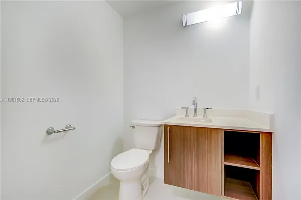 a bathroom with a sink a toilet and vanity