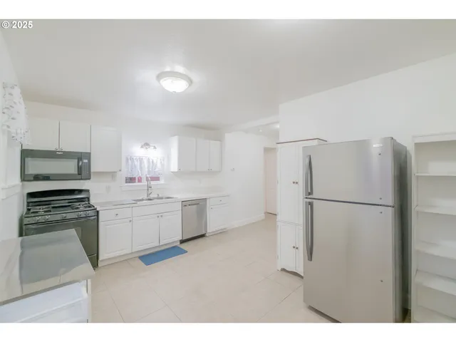 a room with a refrigerator and a sink