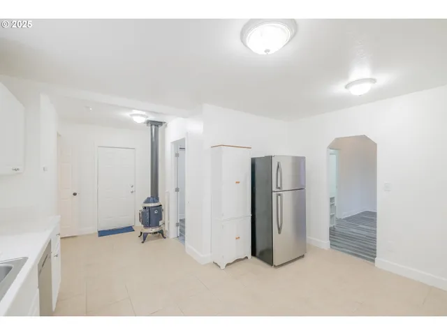 a kitchen with granite countertop a sink stove and refrigerator