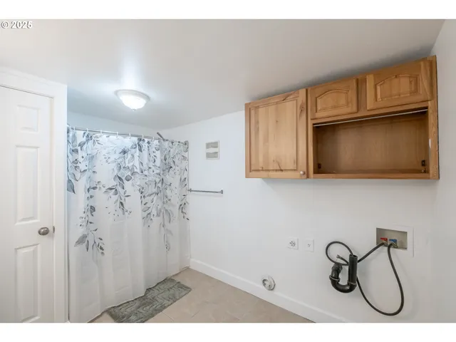 a bathroom with a toilet sink a mirror and shower