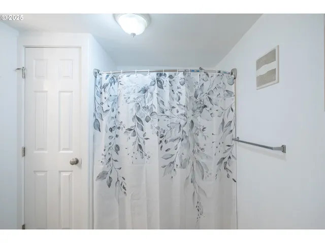 a view of a backyard with wooden fence