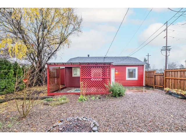 a view of a backyard with wooden fence