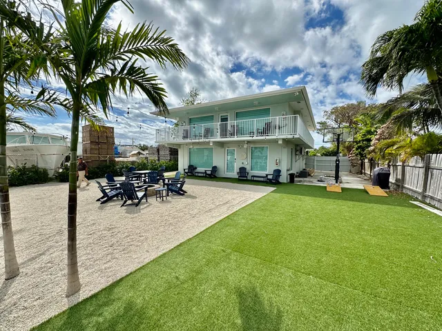 a view of a house with swimming pool and sitting area