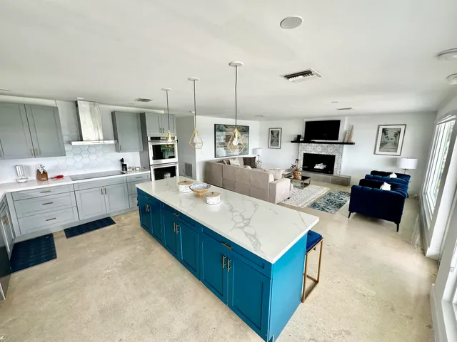 a living room with lots of furniture and a wooden floor