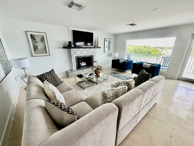 a living room with furniture flat screen tv and a fireplace