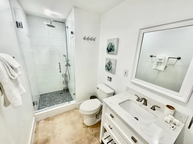 a bathroom with a shower toilet and sink