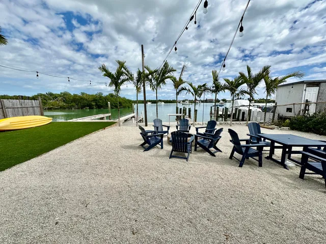 a view of a patio with table and chairs and potted plants