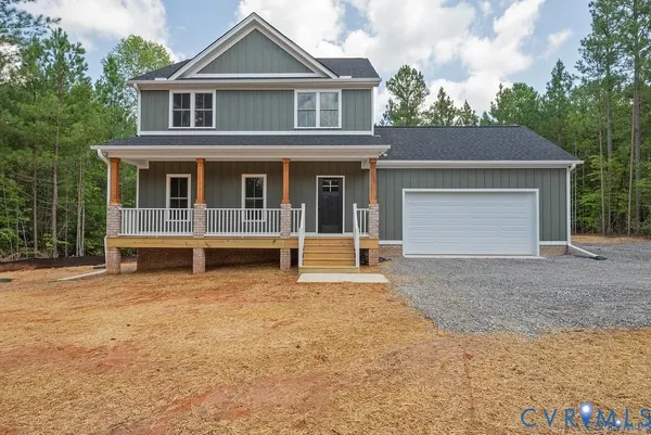 a view of a house with a yard and garage