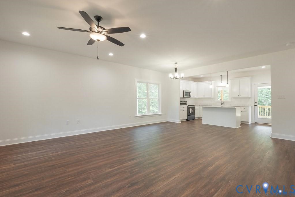 Lot 1 Robertson Town Road Bumpass, VA 23024 - Photo 11 of 40 a view of an empty room with wooden floor and a kitchen