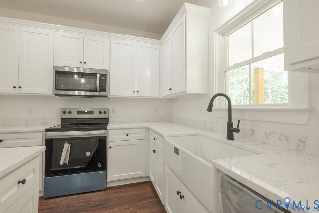 Lot 1 Robertson Town Road Bumpass, VA 23024 - Photo 18 of 40 a kitchen with stainless steel appliances granite countertop a stove a sink and a microwave