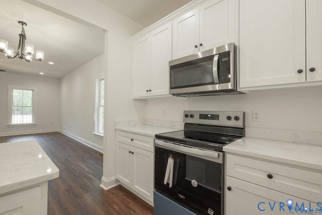 Lot 1 Robertson Town Road Bumpass, VA 23024 - Photo 19 of 40 a kitchen with stainless steel appliances white cabinets and stove top oven