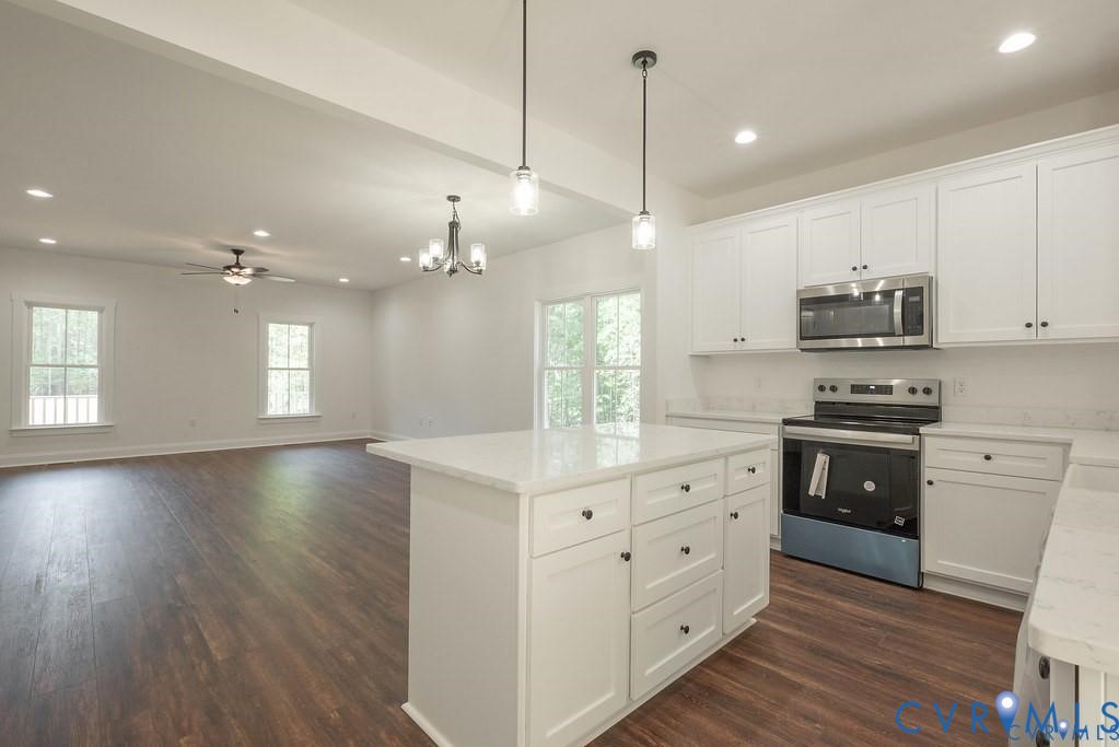 Lot 1 Robertson Town Road Bumpass, VA 23024 - Photo 21 of 40 a kitchen with stainless steel appliances granite countertop a sink a stove a refrigerator and white cabinets with wooden floor