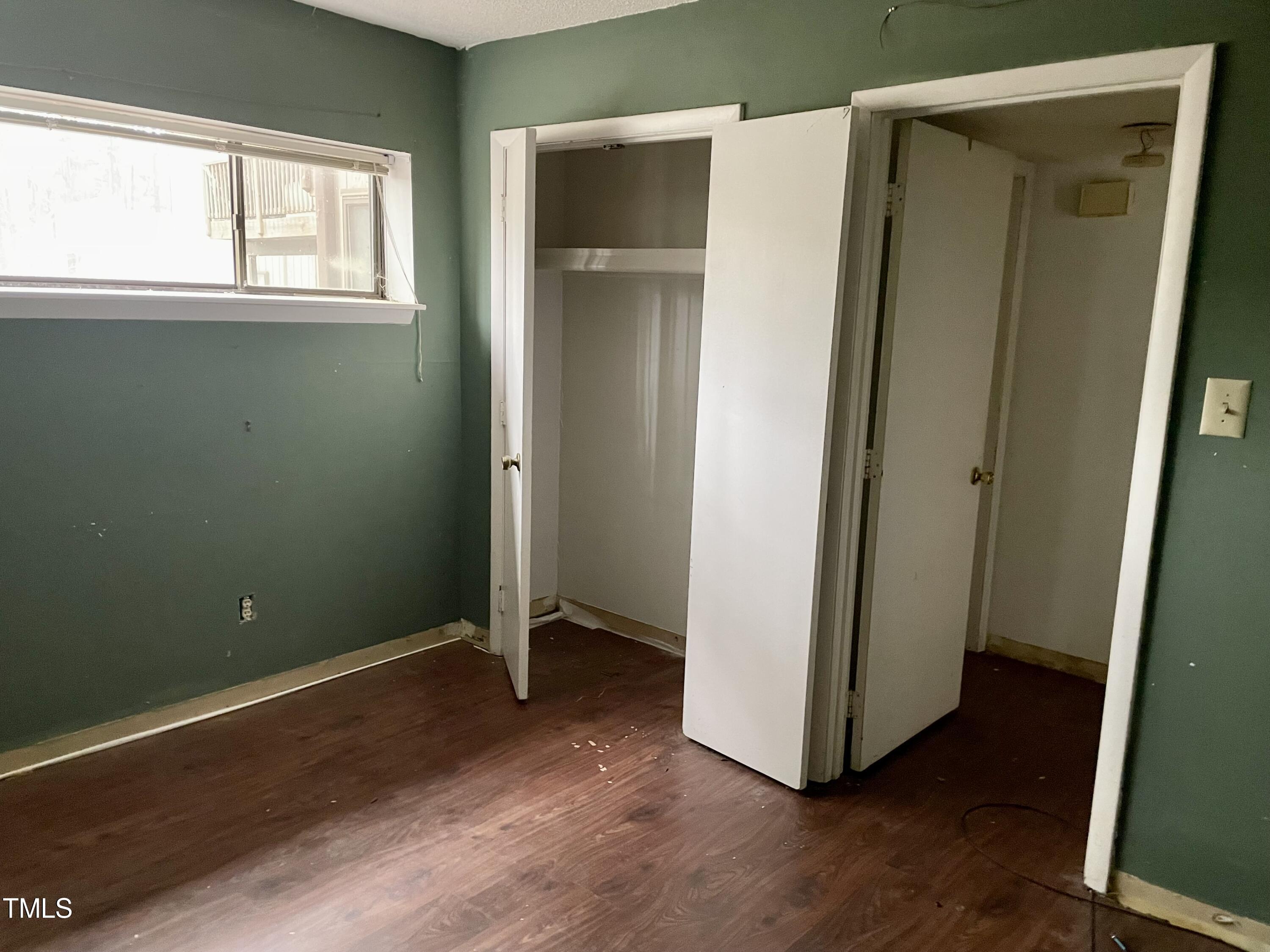 665 Pine Ridge Place Raleigh, NC 27609 - Photo 5 of 14 a view of an empty room with wooden floor and a window