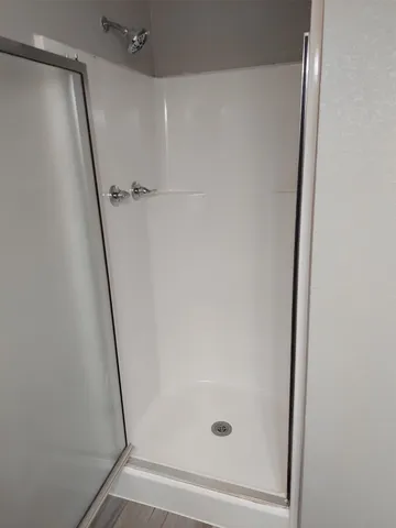 a bathroom with a glass shower door