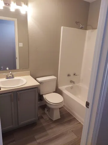 an empty room with wooden floor and closet