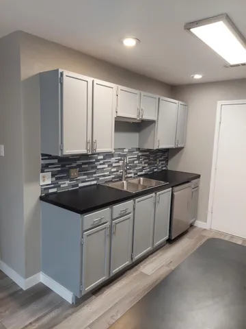 a kitchen with kitchen island stainless steel appliances a sink stove and refrigerator