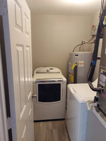 a kitchen with stainless steel appliances granite countertop a refrigerator a stove a sink and a microwave