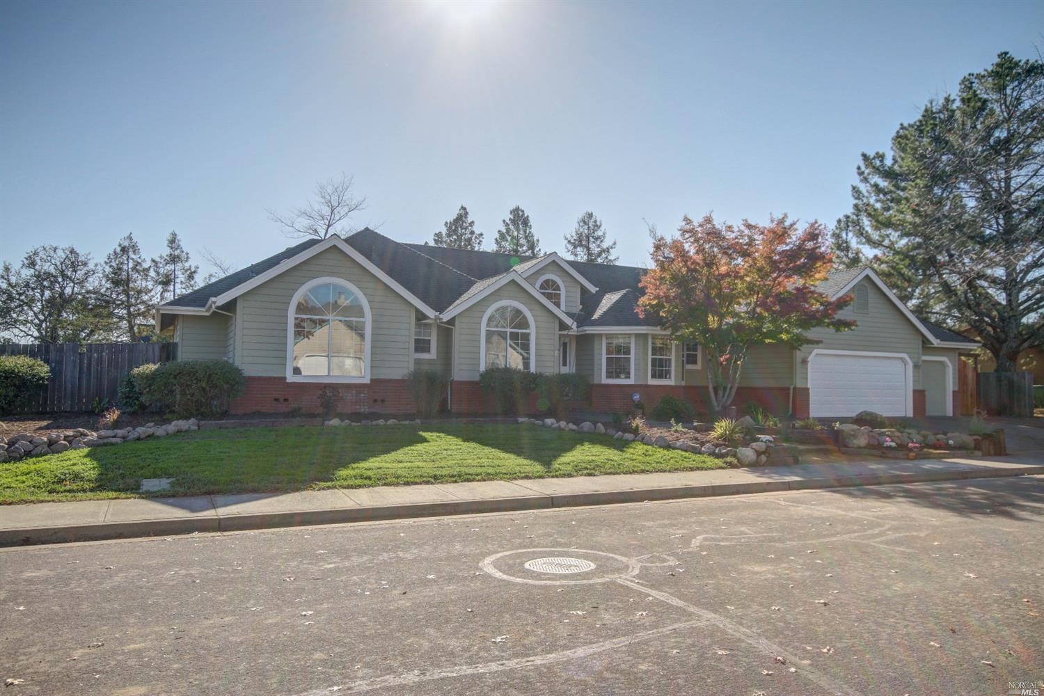 a front view of house with yard and green space