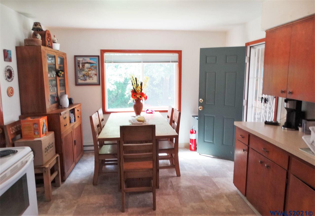 12615 Fishback Road Monmouth, OR 97361 - Photo 7 of 21 a dining room with furniture and a flat screen tv