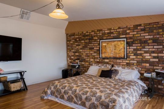 308 West Howell Avenue Ridgecrest, CA 93555 - Photo 17 of 32 a bedroom with a bed and a flat screen tv