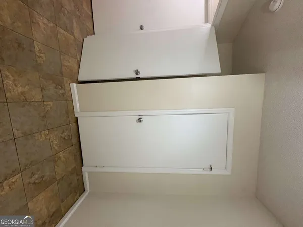 an empty room with a chandelier fan