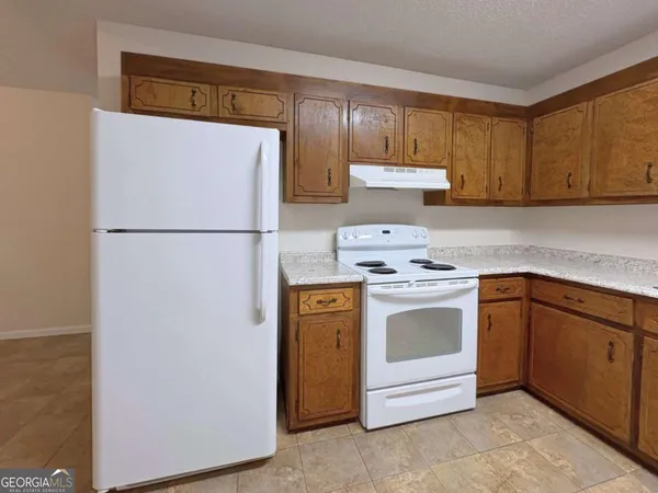 a white refrigerator freezer sitting in a kitchen
