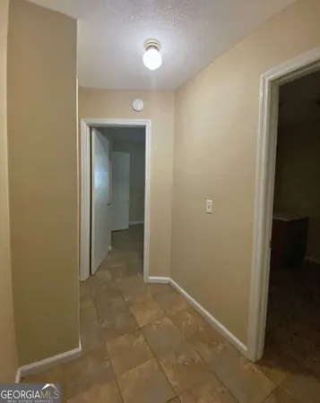 an empty room with closet and a bathroom