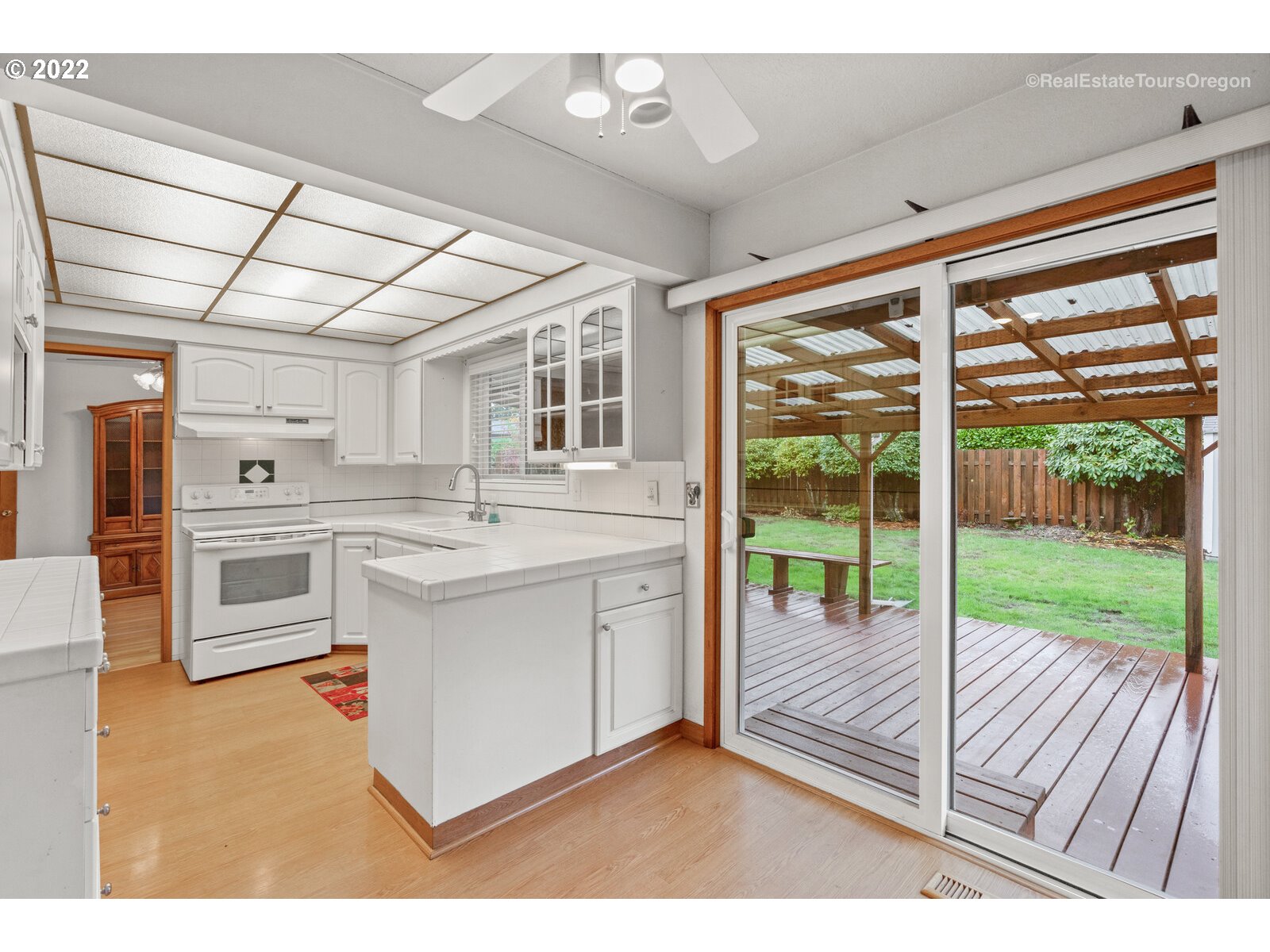 16901 Southeast Haig Street Portland, OR 97236 - Photo 11 of 32 a kitchen with kitchen island a sink and a large window