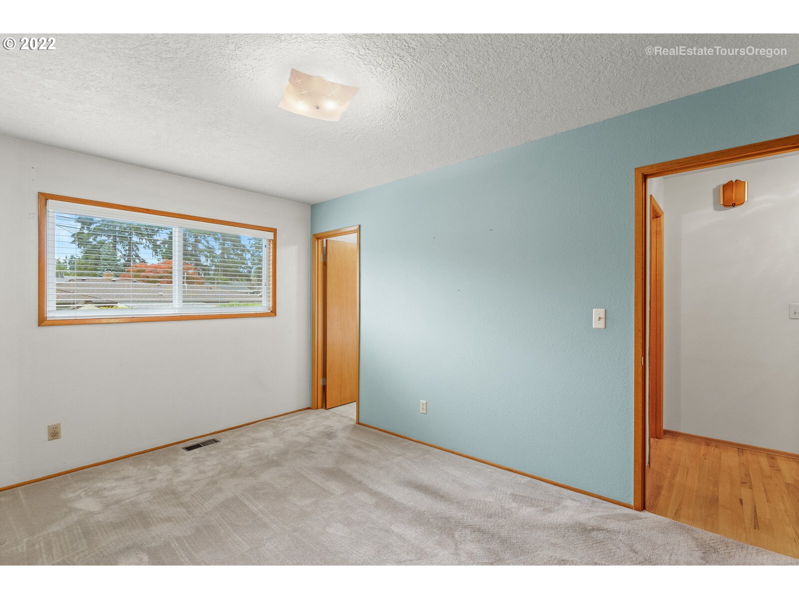 16901 Southeast Haig Street Portland, OR 97236 - Photo 13 of 32 a view of an empty room with wooden floor