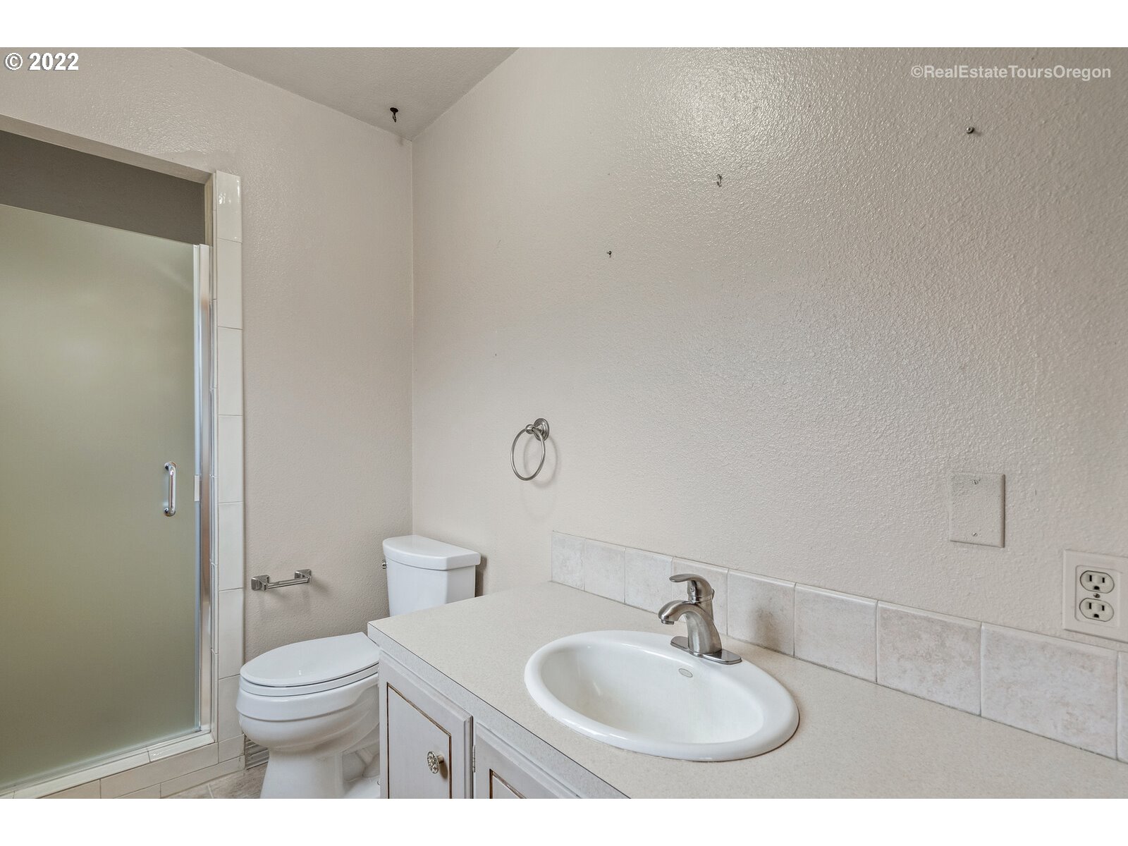 16901 Southeast Haig Street Portland, OR 97236 - Photo 15 of 32 a bathroom with a sink a toilet and a mirror
