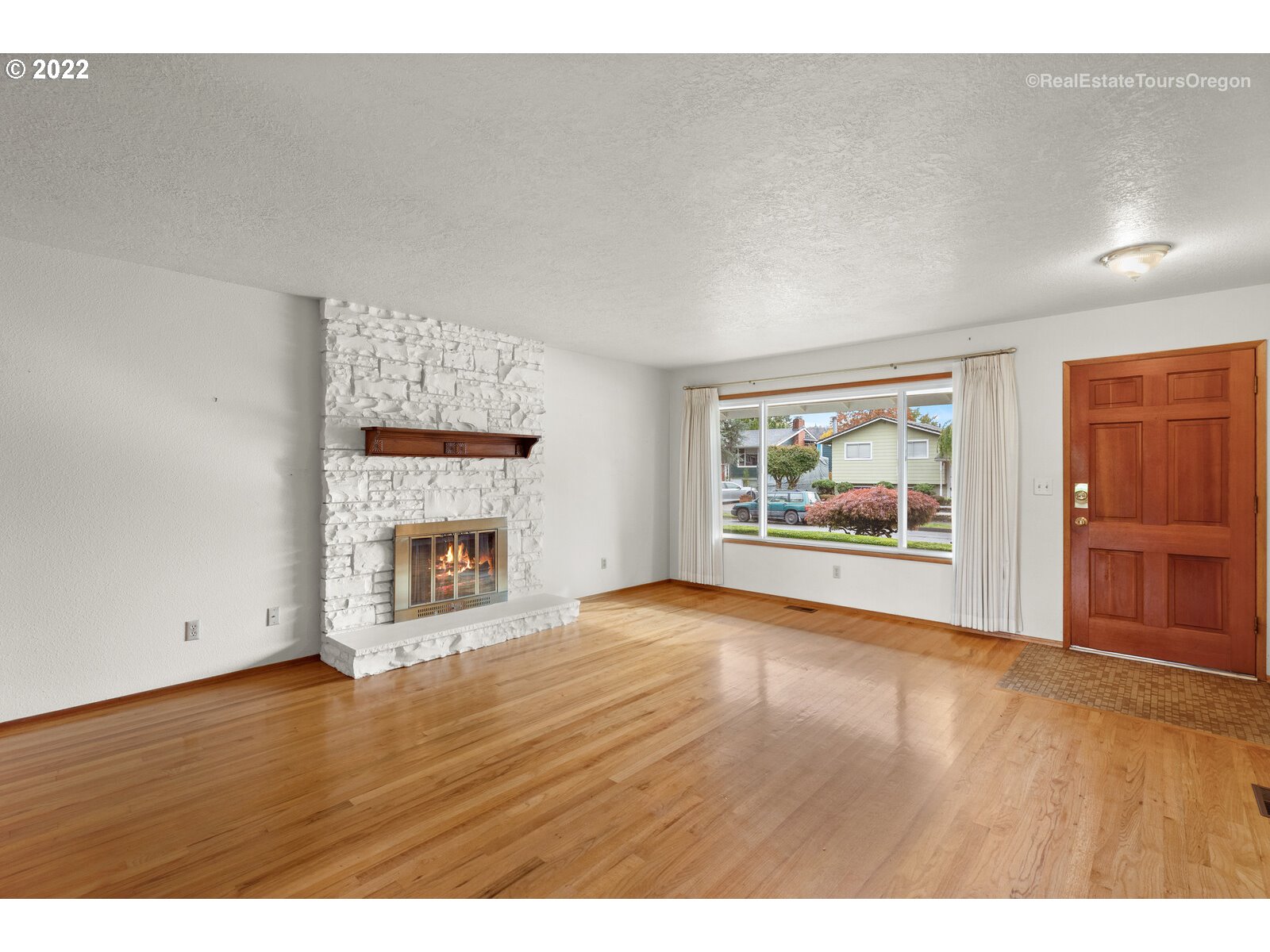 16901 Southeast Haig Street Portland, OR 97236 - Photo 5 of 32 a view of an empty room with a fireplace and window