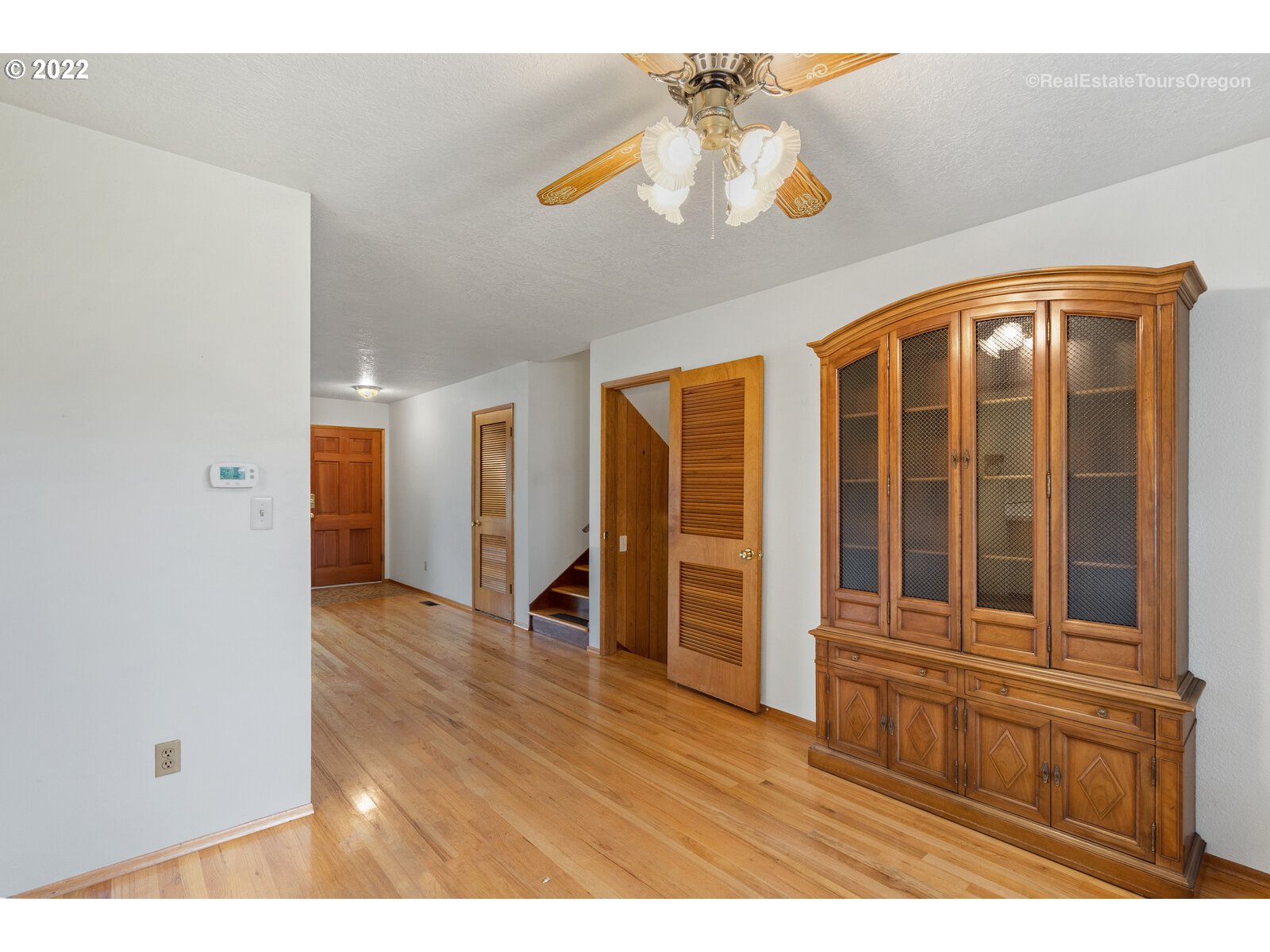 16901 Southeast Haig Street Portland, OR 97236 - Photo 7 of 32 a view of empty room with wooden floor and fan