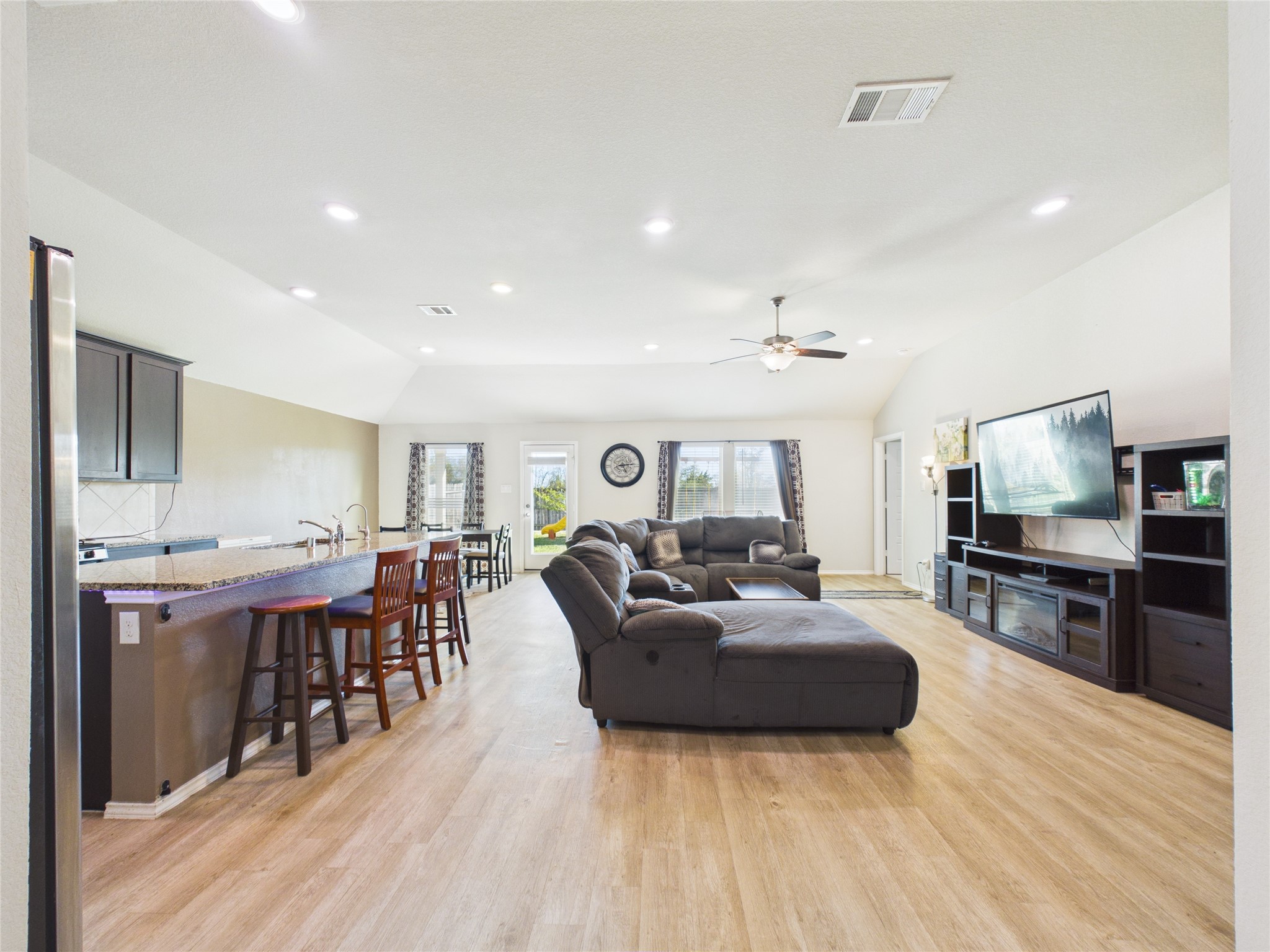 1237 Steed Bluff Drive Alvin, TX 77511 - Photo 9 of 50 a living room with furniture a flat screen tv and kitchen view