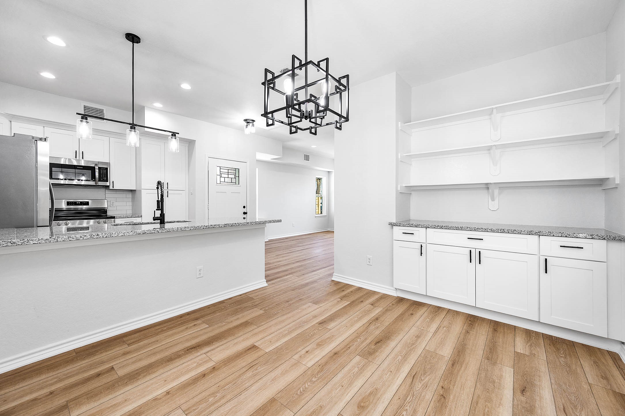 2020 Hampton Street, Unit A B Houston, TX 77088 - Photo 7 of 31 a view of a kitchen with kitchen island a sink stainless steel appliances and cabinets