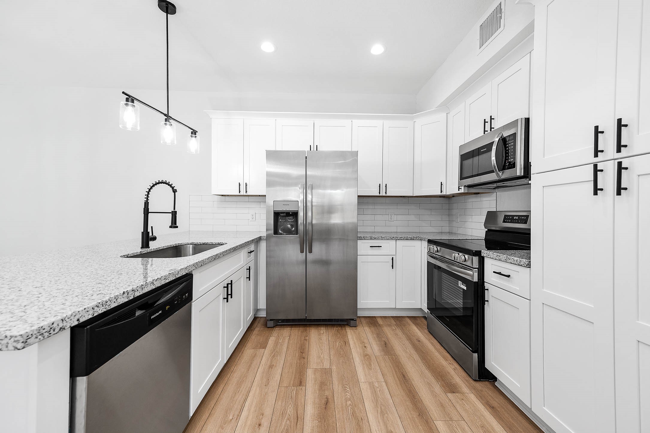 2020 Hampton Street, Unit A B Houston, TX 77088 - Photo 9 of 31 a kitchen with stainless steel appliances granite countertop a sink stove and refrigerator