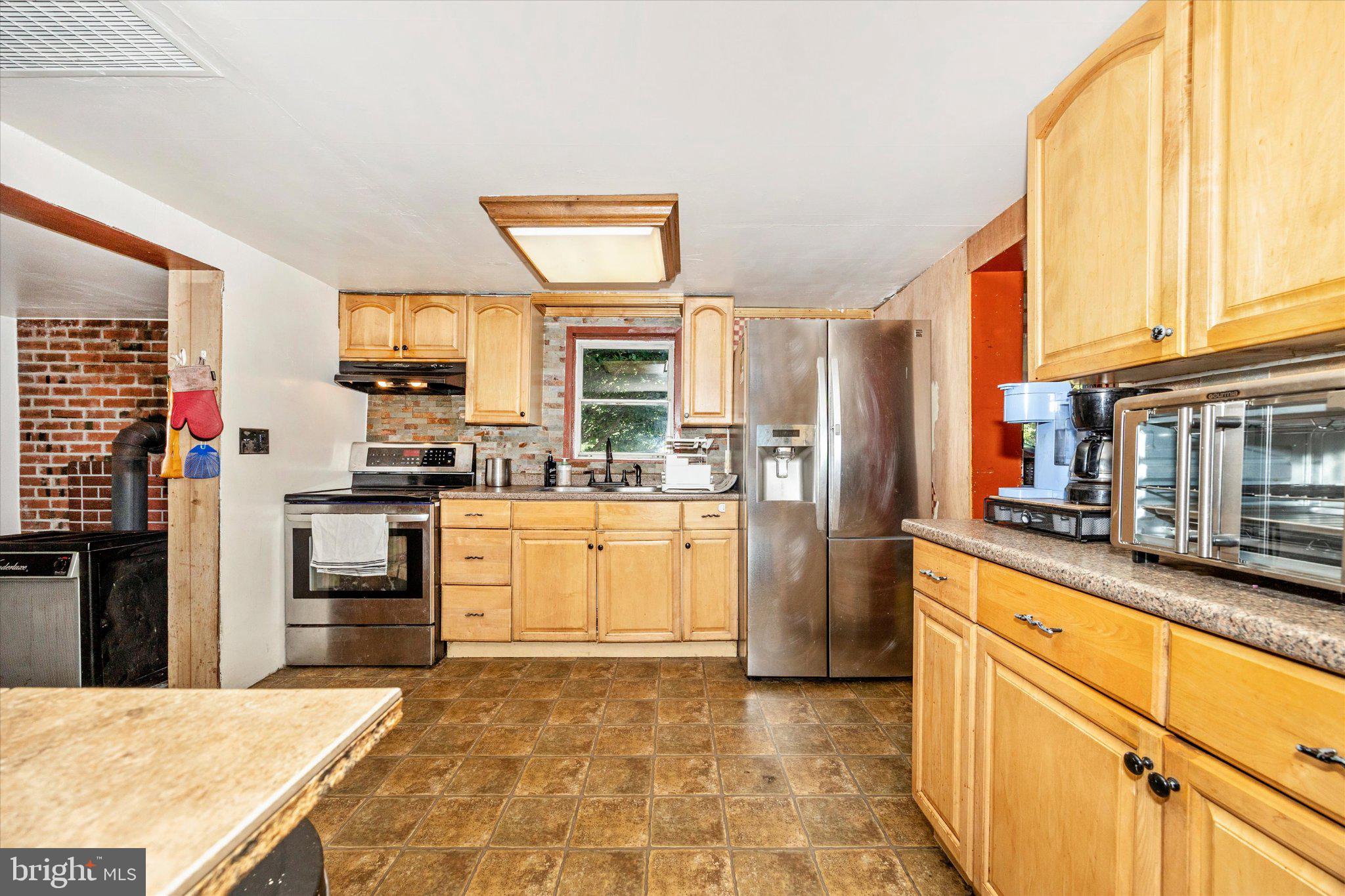 14721 Albert Staub Road Thurmont, MD 21788 - Photo 3 of 46 a kitchen with stainless steel appliances granite countertop a refrigerator and a stove top oven