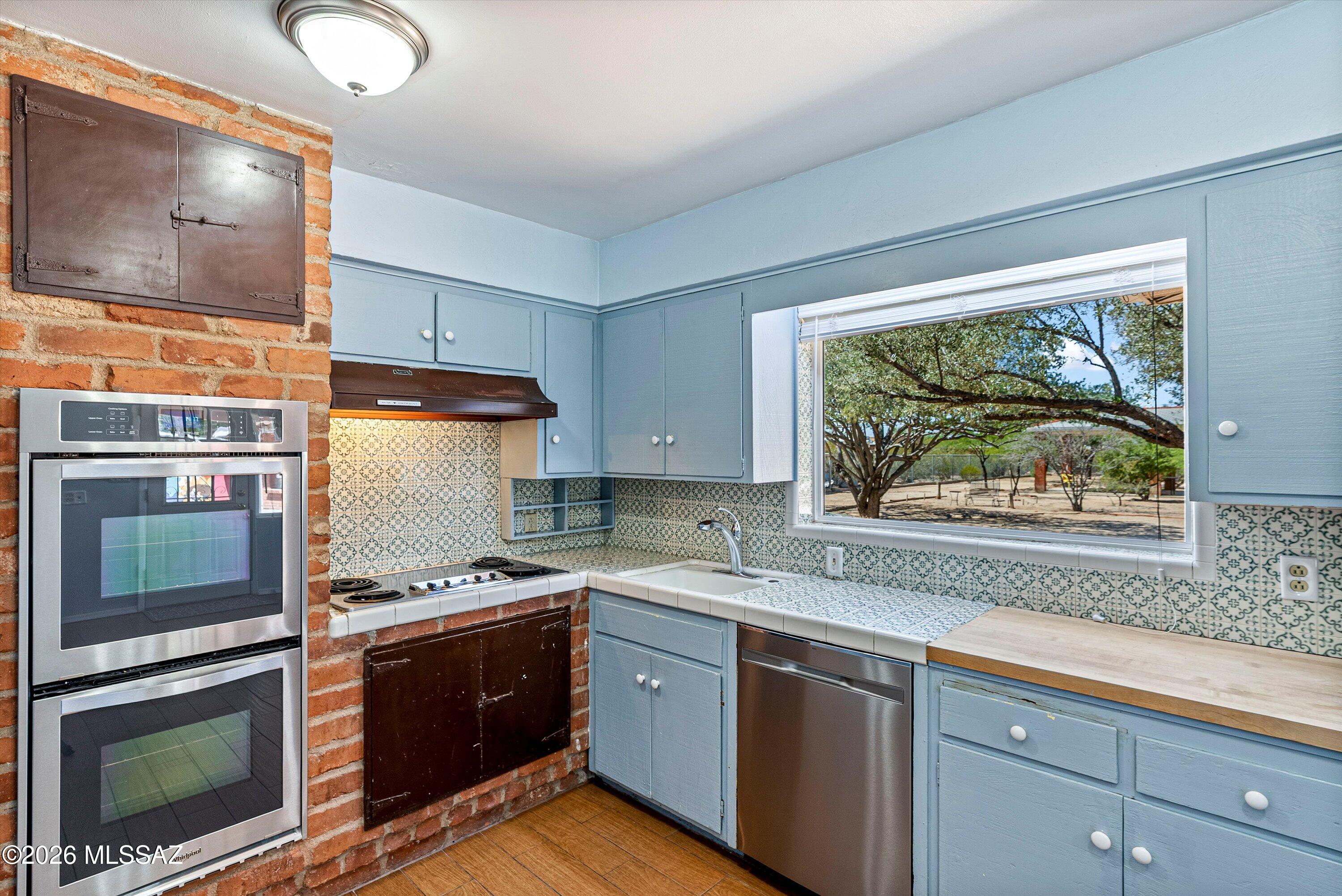 2107 East Lind Road Tucson, AZ 85719 - Photo 18 of 43 a kitchen with stainless steel appliances a stove sink and microwave