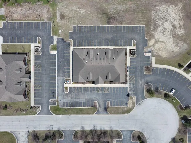 an aerial view of a house with garden space and swimming pool