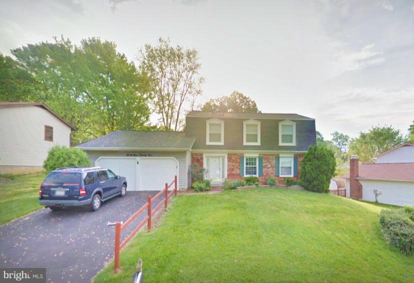 6925 Spur Road Springfield, VA 22153 - Photo 1 of 1 a front view of a house with a garden and trees