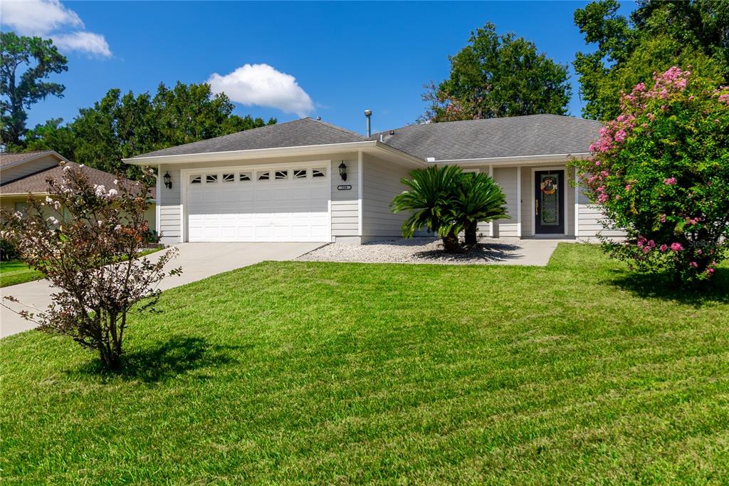 508 Northwest 94th Way Gainesville, FL 32607 - Photo 1 of 30 a view of a house with a small yard and a large tree