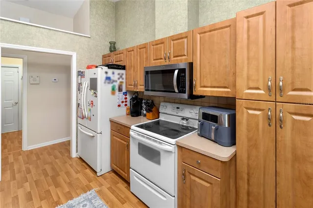 a kitchen with stainless steel appliances a stove a microwave and a refrigerator