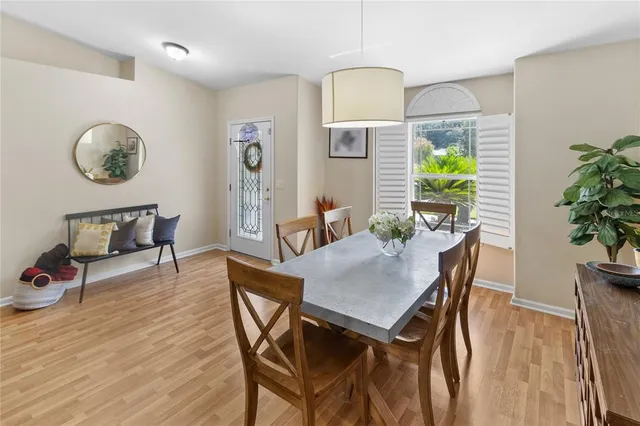 a view of a dining room with furniture and a potted plant