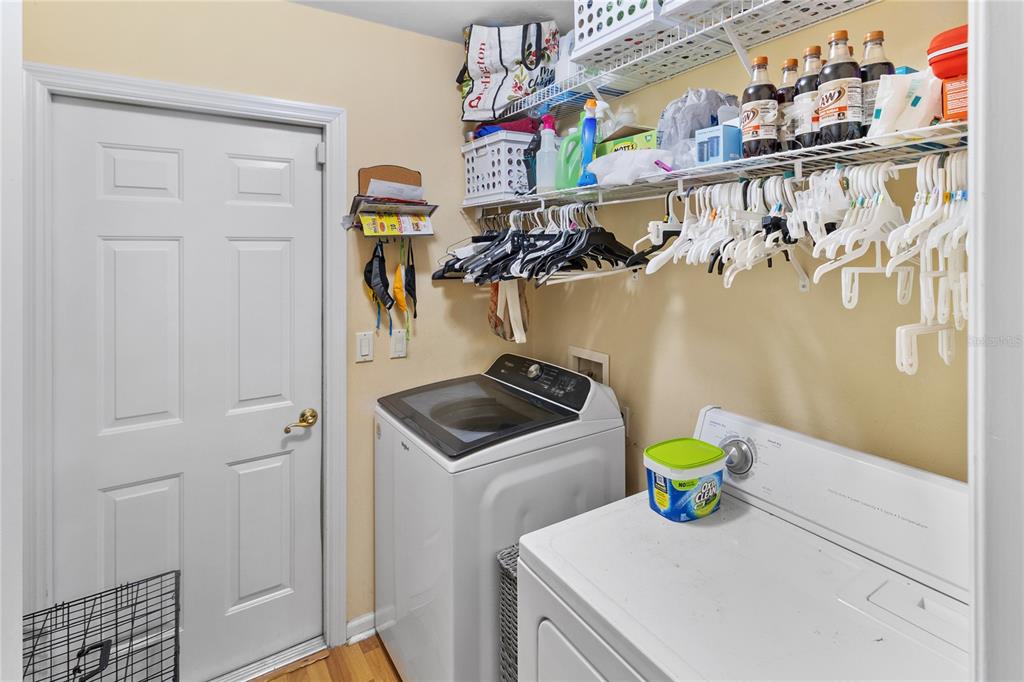508 Northwest 94th Way Gainesville, FL 32607 - Photo 22 of 30 a kitchen with a refrigerator a stove and wooden floor