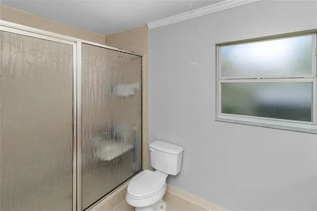 a bathroom with a shower a toilet and a sink