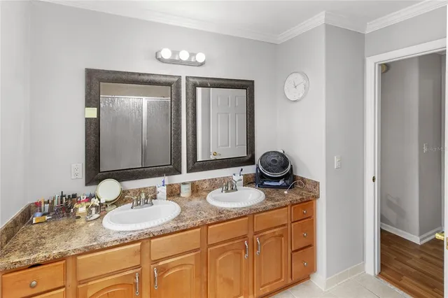 a bathroom with double sink and a mirror