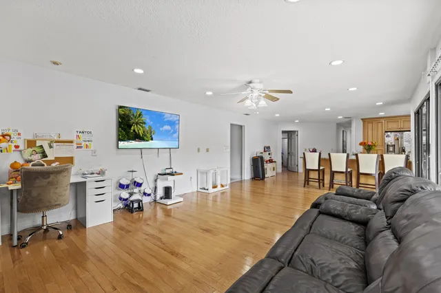 a view of a dining room with furniture a chandelier and wooden floor