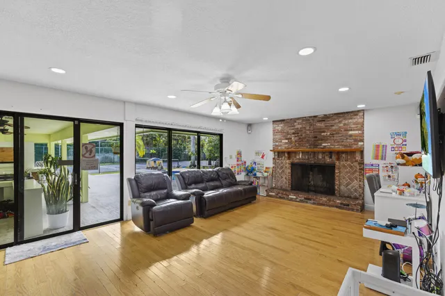 a kitchen with stainless steel appliances granite countertop a refrigerator stove top oven dining table and chairs