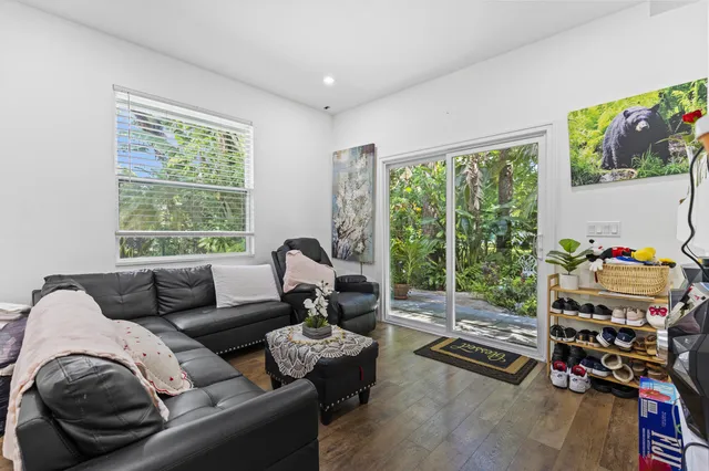 a bedroom with a bed and a flat tv screen on dresser