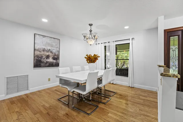 a bathroom with a granite countertop sink a toilet and a mirror