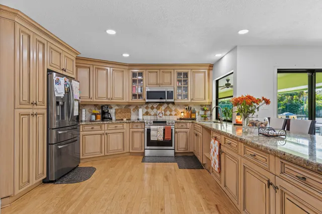 a bathroom with a granite countertop sink a toilet and a mirror